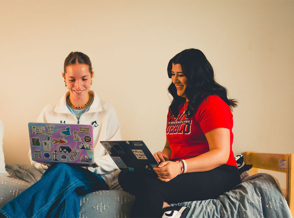 students viewing laptop