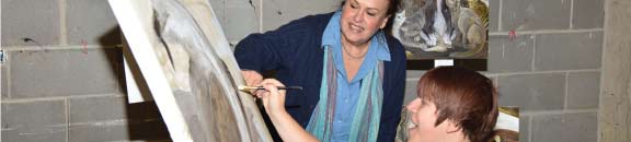 professor giving feedback on painting