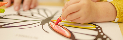child drawing a butterfly