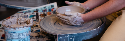Hands molding clay. 