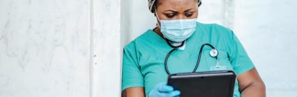 Nurse in mask and nursing scrubs