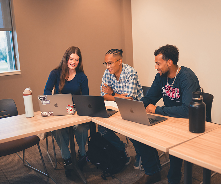 three students with laptop