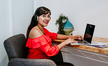 Adult learner with a laptop looking at camera