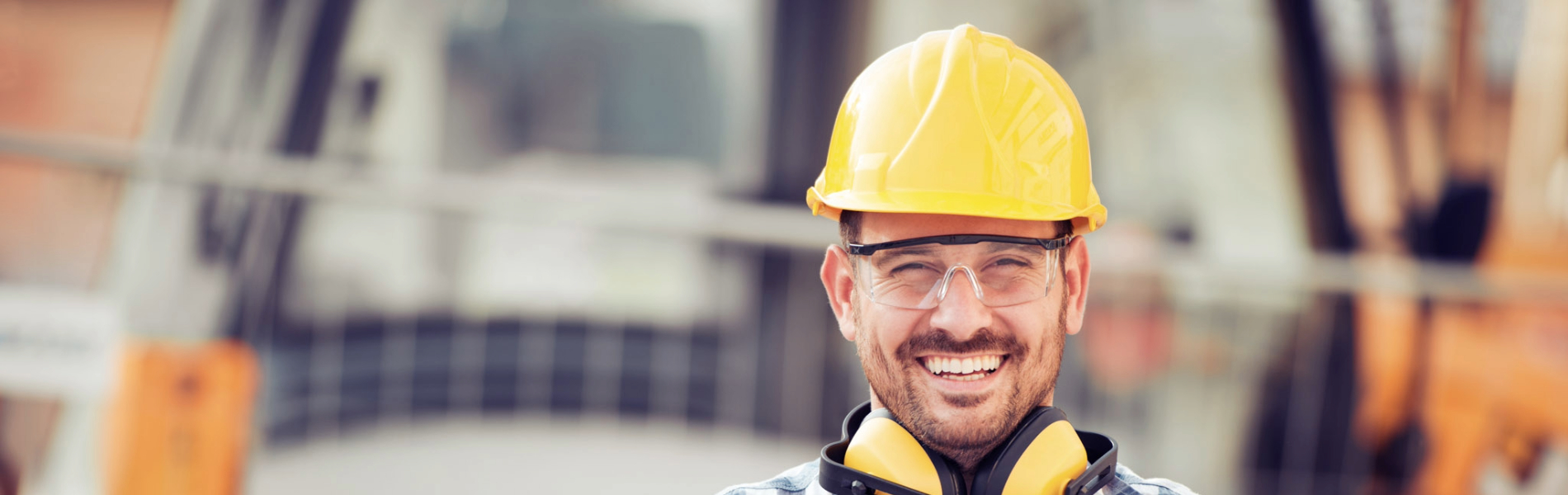 Construction worker smiling with his arms crossed