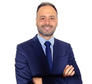 Husam Alshareef smiling with arms crossed