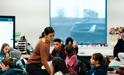 teacher holding mic and talking to students